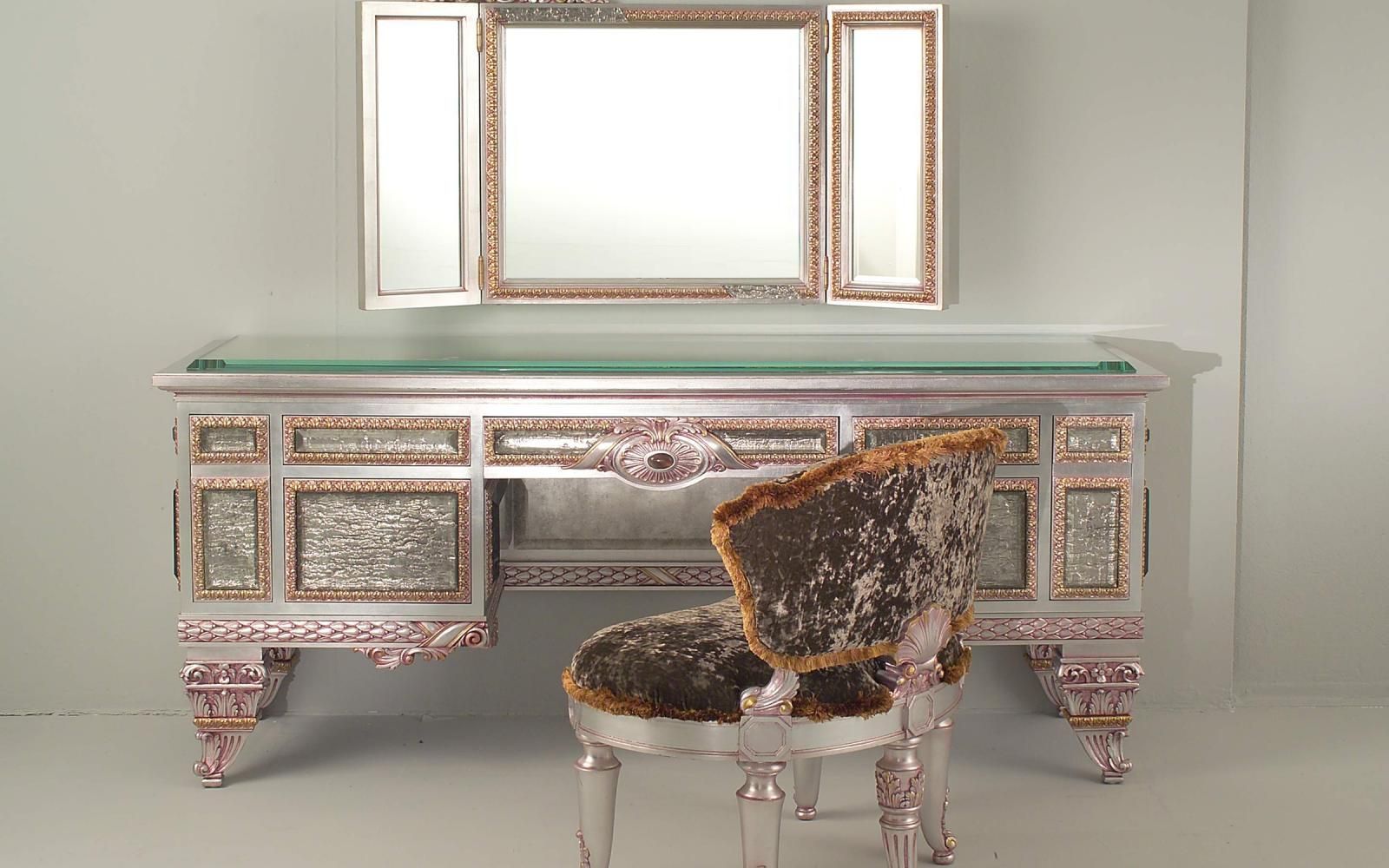 A hand-finished vanity with mirror and upholstered chair